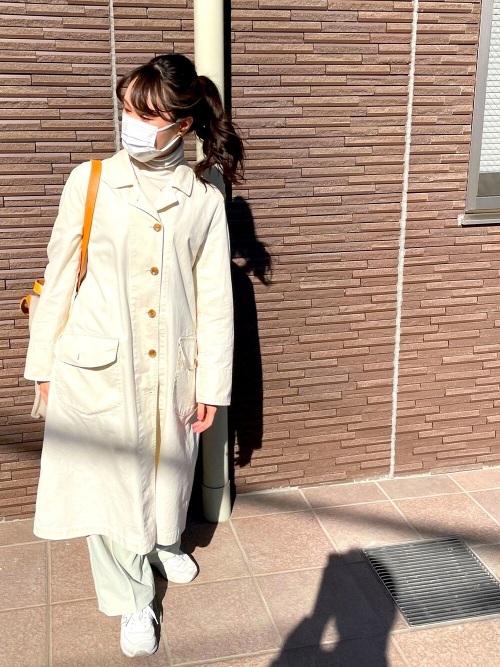 ホワイト系のニット/セーター、ベージュ系のジャケット/アウター、グレー系のトートバッグを着用したレディースの冬コーディネートの1枚目の写真