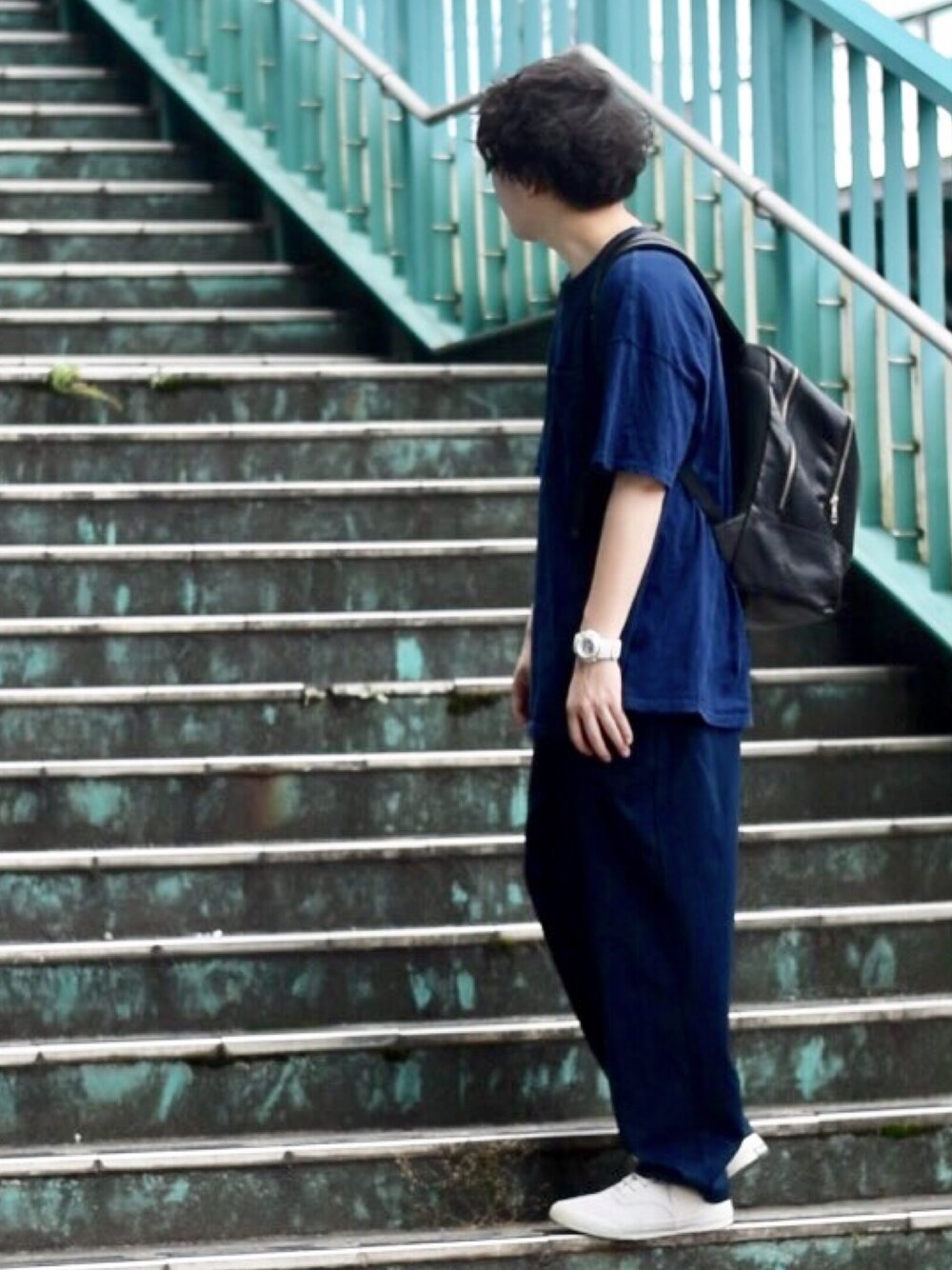 ホワイト系のスニーカー、ブルー系のパンツ、ブルー系のTシャツ/カットソーを着用したメンズの夏コーディネートの1枚目の写真