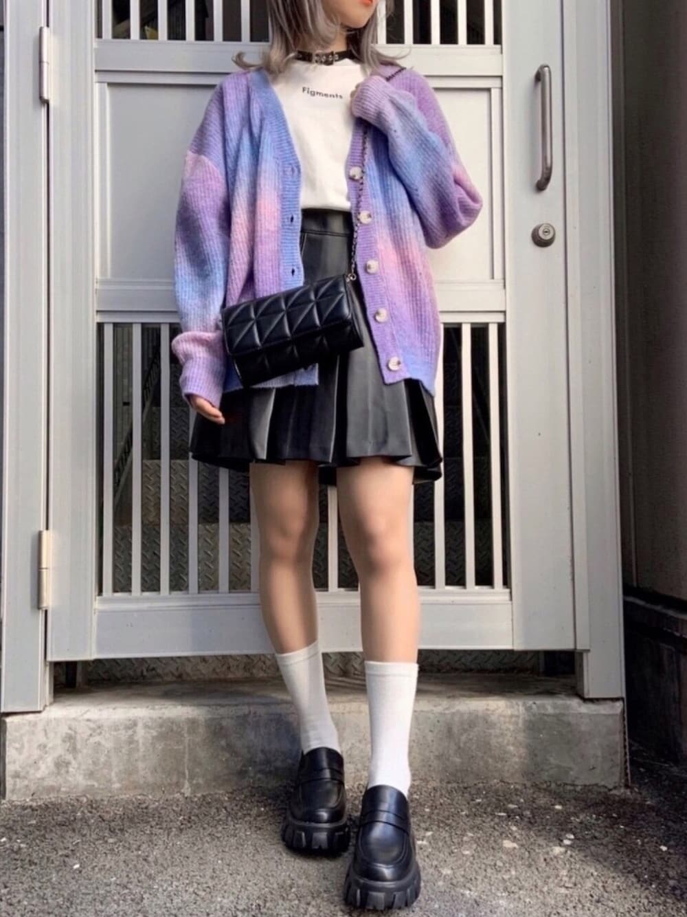 ブラック系のスカート、ホワイト系のTシャツ/カットソー、ブラック系のショルダーバッグを着用したレディースの冬コーディネートの1枚目の写真