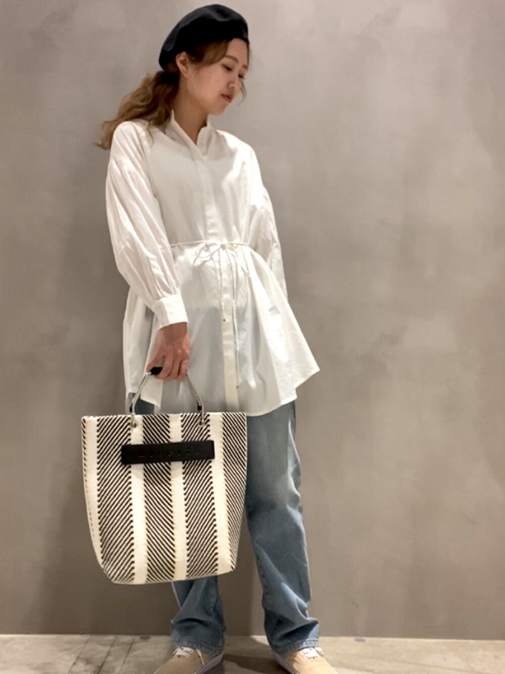 ホワイト系のシャツ/ブラウス、ブラック系のトートバッグ、ブルー系のデニムパンツを着用したレディースの春コーディネートの1枚目の写真