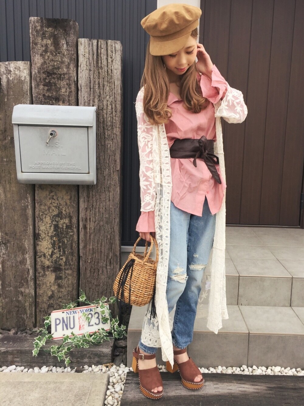 ピンク系のシャツ/ブラウス、デニムパンツ、ベージュ系のかごバッグを着用したレディースの春コーディネートの1枚目の写真