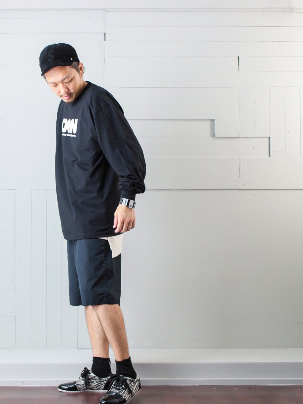 ブラック系のTシャツ/カットソー、ブラック系のパンツ、ホワイト系のタンクトップを着用したメンズの秋コーディネートの1枚目の写真