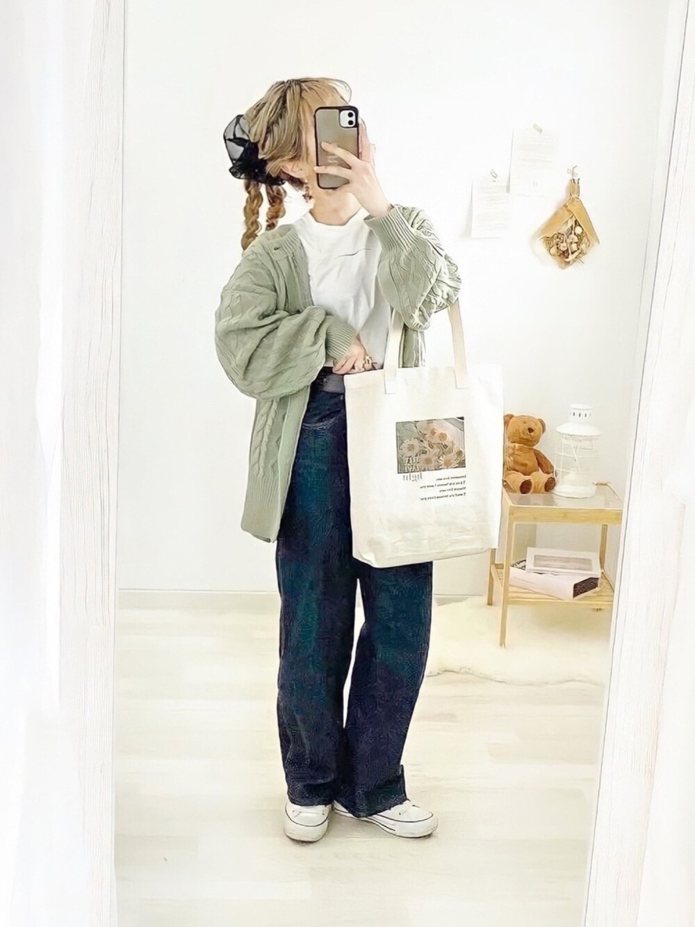 グリーン系のカーディガン/ボレロ、ホワイト系のTシャツ/カットソー、ホワイト系のスニーカーを着用したレディースの冬コーディネートの1枚目の写真