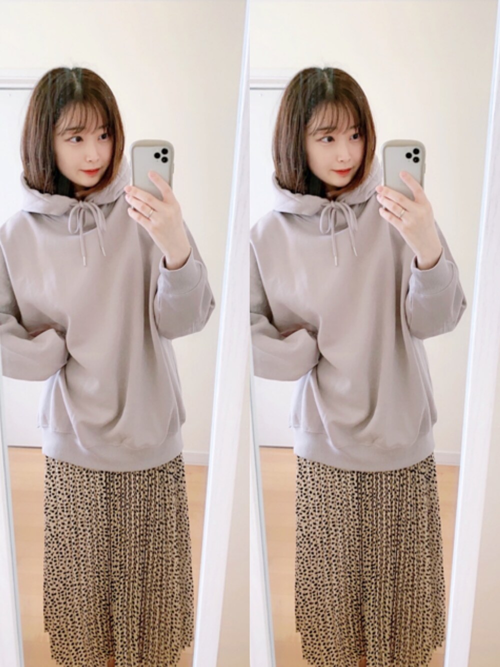 ピンク系のスカート、ベージュ系のパーカーを着用したレディースの秋コーディネートの1枚目の写真
