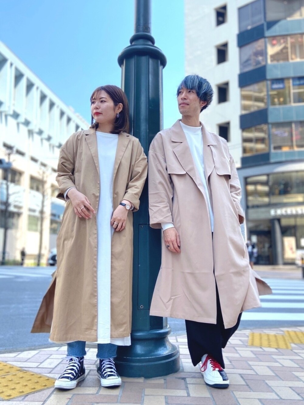 グリーン系のトレンチコート、ホワイト系のTシャツ/カットソー、ブラック系のその他パンツを着用したレディースの春コーディネートの1枚目の写真