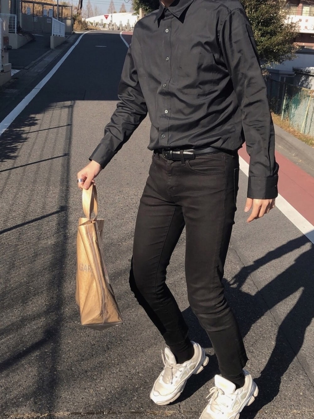 「チョコ色に染まれ、UNIQLO、コムデギャルソン、PVCトート、COMME des GARCONS、黒シャツ、ピシッと、春コーデ、韓国ファッション、ダットスニーカー」｜「RAF SIMONSのアイテム（スニーカー、ホワイト系）」を使った、hさん（メンズ・175cm）の冬コーディネートの1枚目の写真
