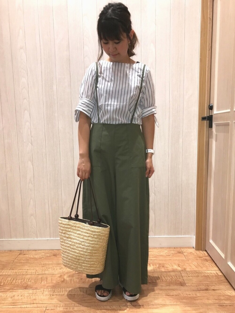 グリーン系のサロペット/オーバーオール、ブラック系のサンダル、ベージュ系のトートバッグを着用したレディースの夏コーディネートの1枚目の写真