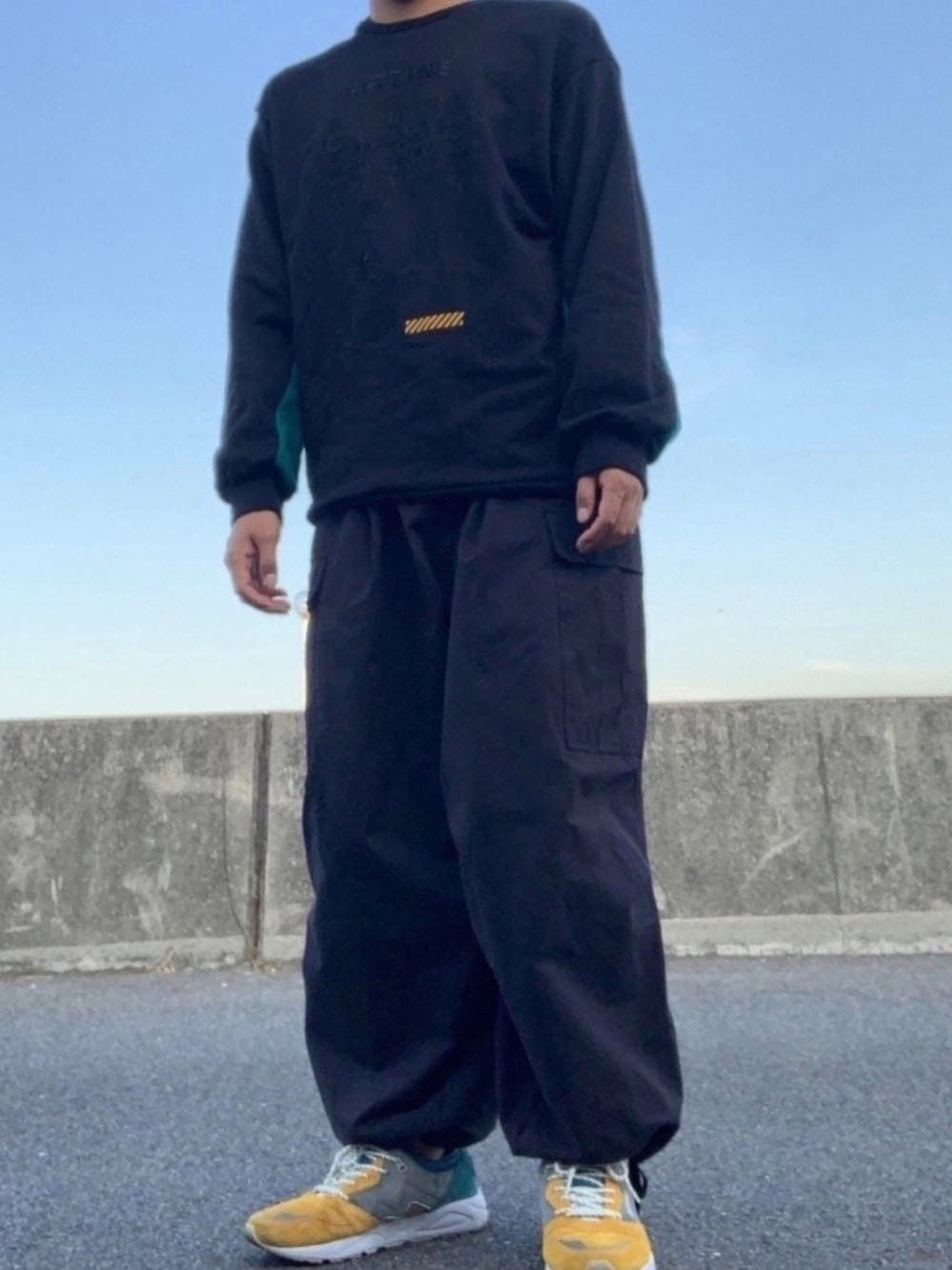 「休日スタイル、ストリート、カジュアルコーデ、ビッグシルエット、オールブラック、SHAREEF、スウェット、KARHU、スニーカー、緑×黄色」｜「SHAREEFの"RF771NE" BIG SWEAT（スウェット、ブラック系）」を使った、九浮さん（メンズ・172cm）の秋コーディネートの1枚目の写真