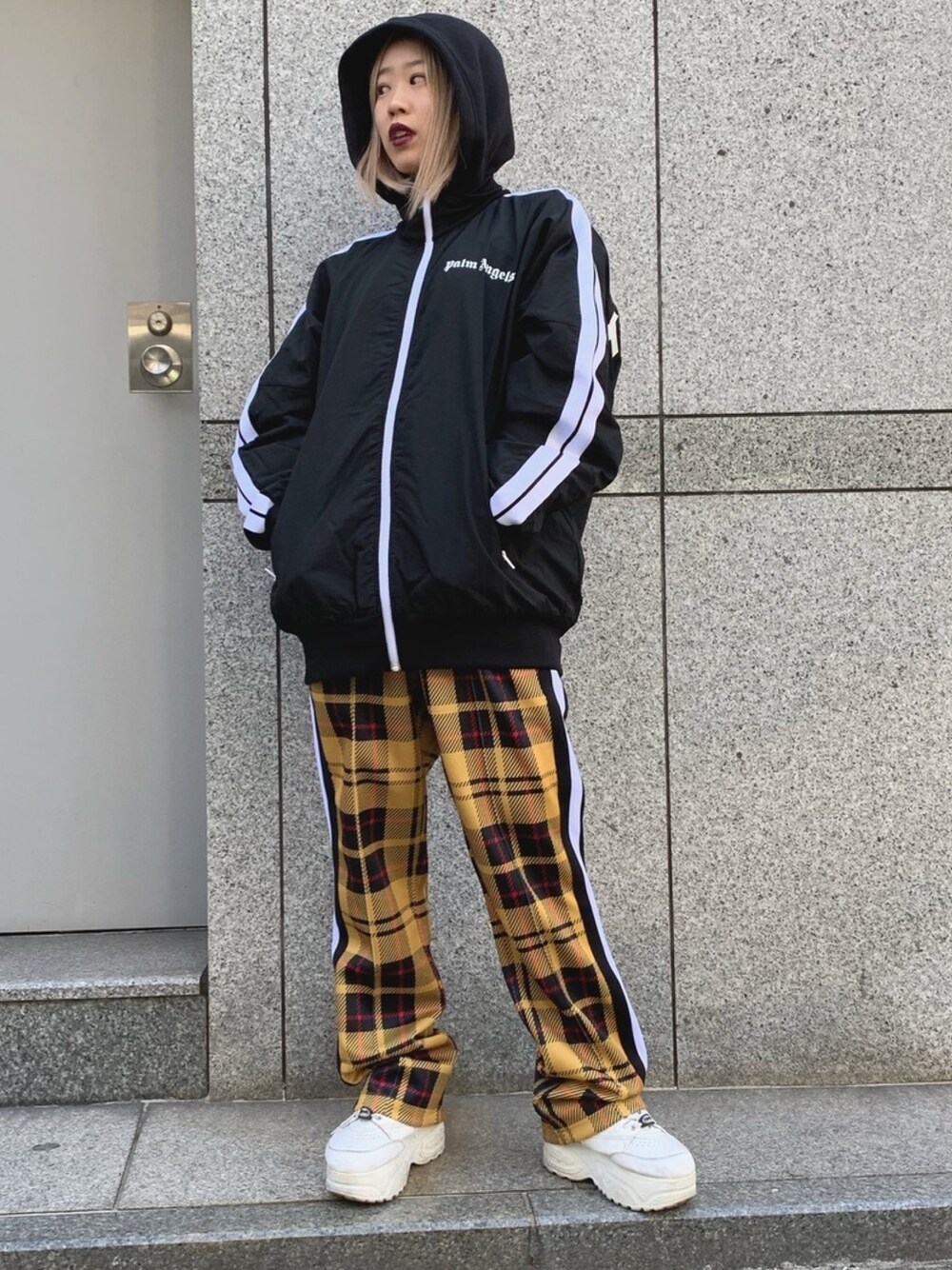 ブラック系のジャケット/アウター、イエロー系のその他パンツを着用したレディースの冬コーディネートの1枚目の写真