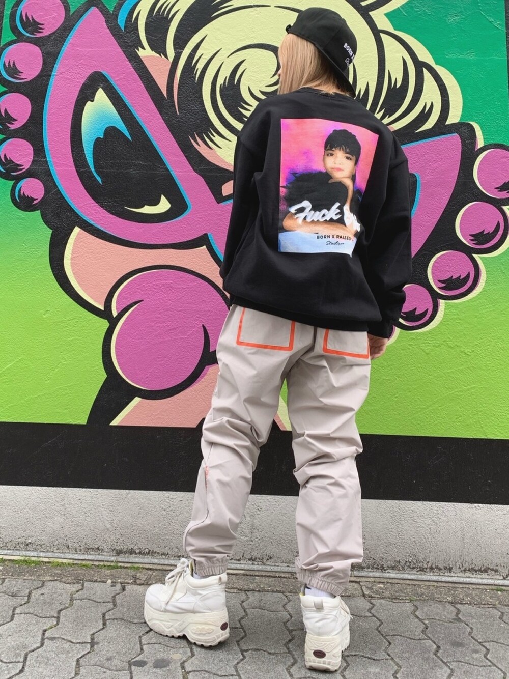 ブラック系のスウェット、ベージュ系のその他パンツ、ブラック系のキャップを着用したレディースの冬コーディネートの1枚目の写真