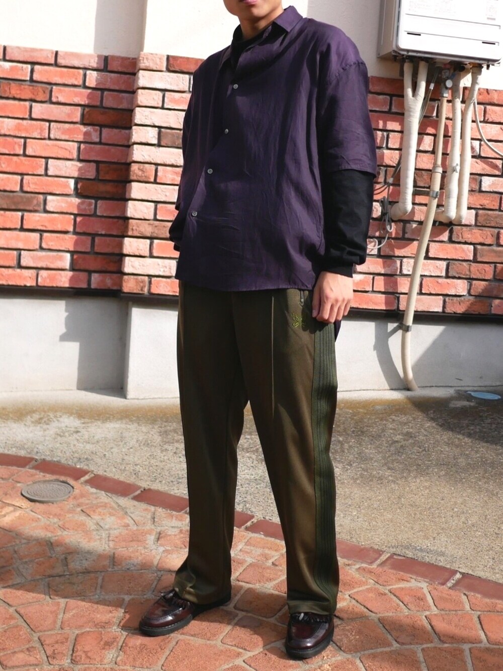 パープル系のシャツ/ブラウス、ブラック系のTシャツ/カットソー、グリーン系のパンツを着用したメンズの秋コーディネートの1枚目の写真