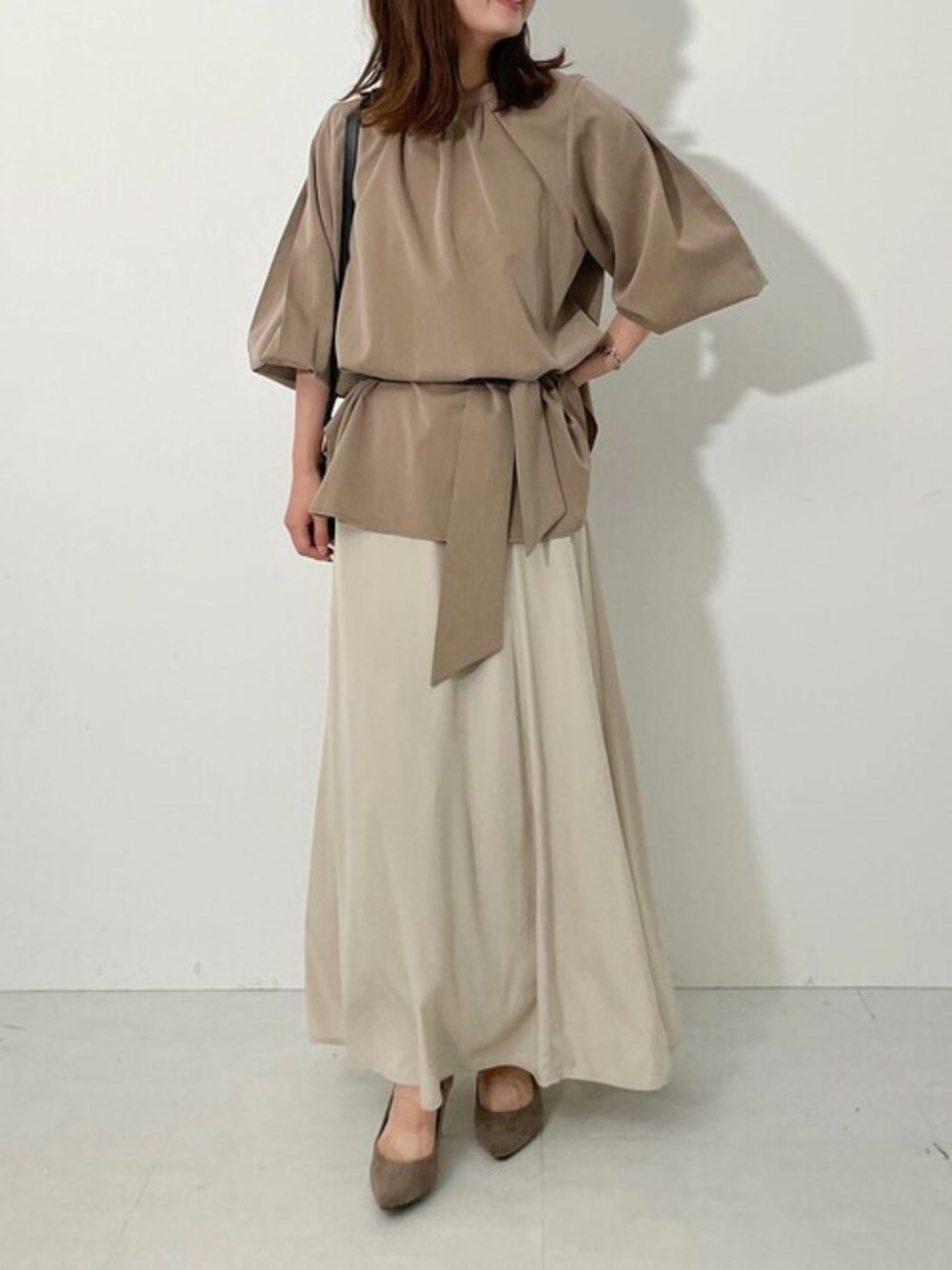 ブラウン系のシャツ/ブラウス、ベージュ系のパンプスを着用したレディースの冬コーディネートの1枚目の写真