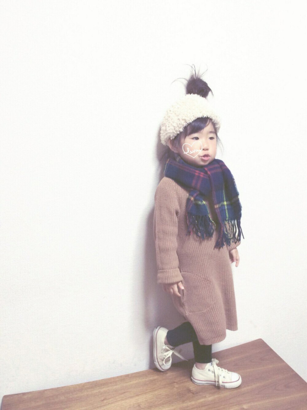 ベージュ系のワンピース、ホワイト系のスニーカー、ベージュ系のヘアバンドを着用したキッズの秋コーディネートの1枚目の写真
