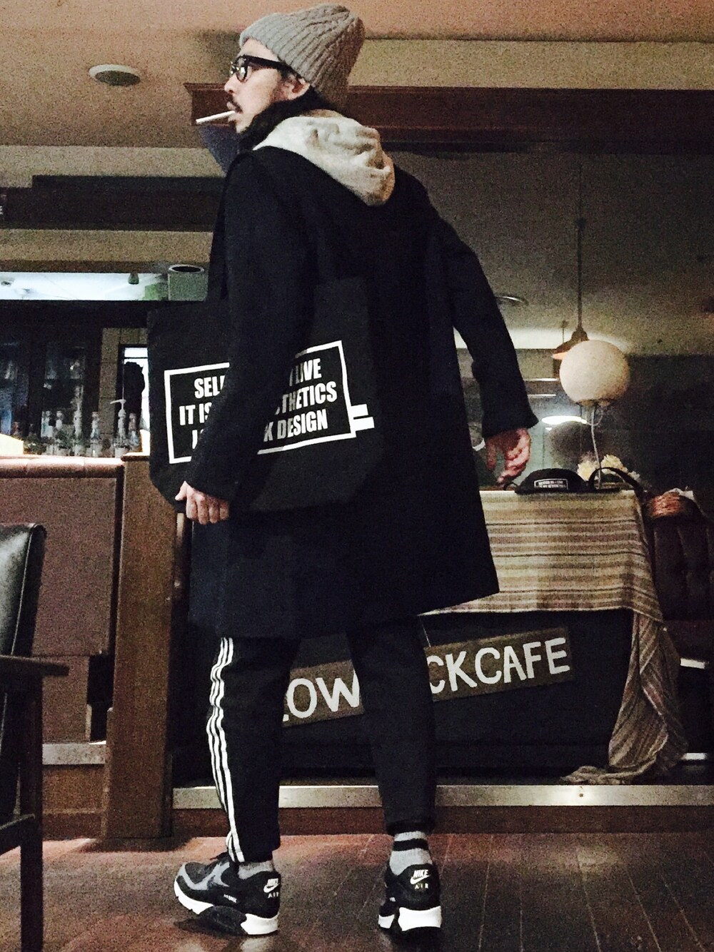 グレー系のパーカー、ブルー系のチェスターコート、ブラック系のその他パンツを着用したメンズの秋コーディネートの1枚目の写真