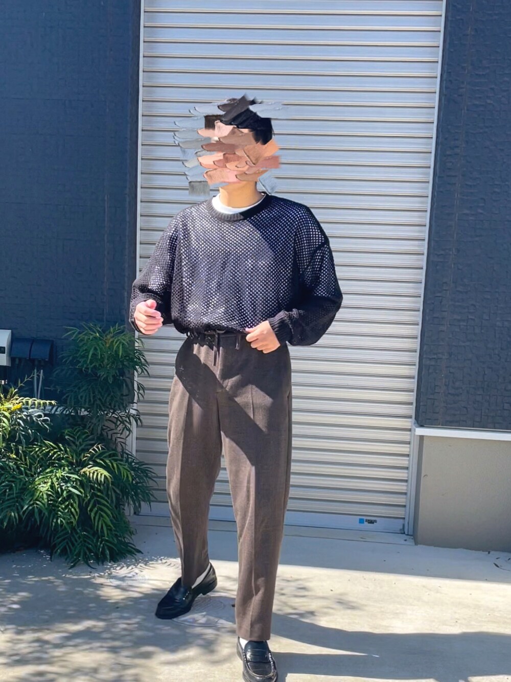 ブラック系のニット/セーター、ホワイト系のTシャツ/カットソー、ブラウン系のパンツを着用したメンズの秋コーディネートの1枚目の写真