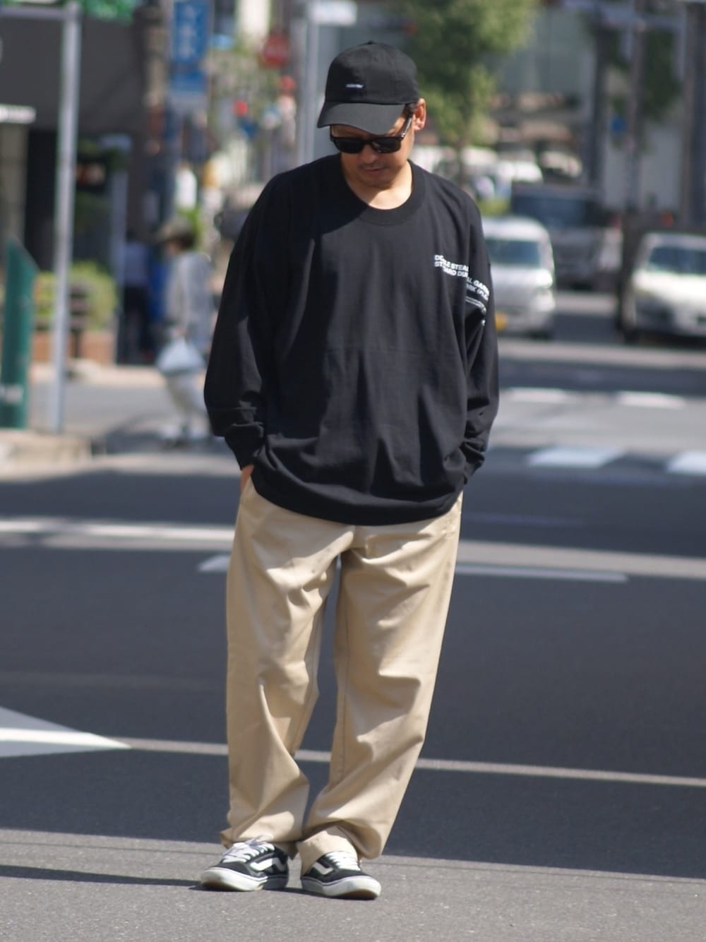 ブラック系のスニーカー、ブラック系のTシャツ/カットソー、ベージュ系のその他パンツを着用したメンズの秋コーディネートの1枚目の写真