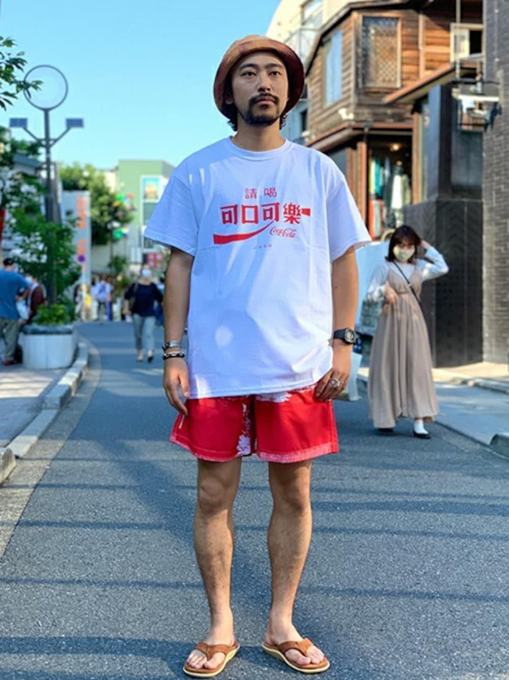 ホワイト系のTシャツ/カットソー、レッド系のその他パンツ、ブラウン系のサンダルを着用したメンズの夏コーディネートの1枚目の写真