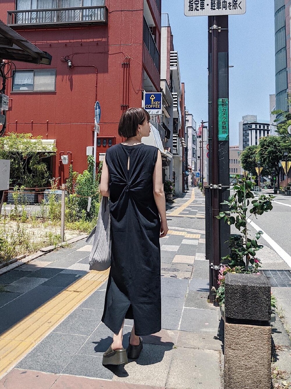 ブラック系のワンピース、グリーン系のサンダル、シルバー系のピアス（両耳用）を着用したレディースの夏コーディネートの1枚目の写真