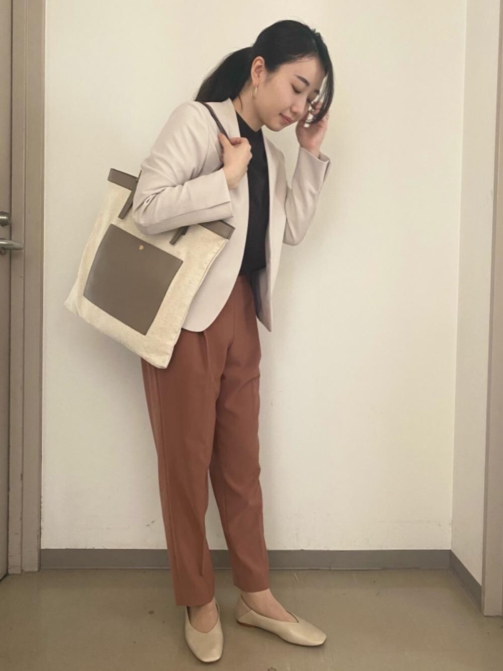 ベージュ系のトートバッグ、オレンジ系のその他パンツ、ベージュ系のその他シューズを着用したレディースの秋コーディネートの1枚目の写真