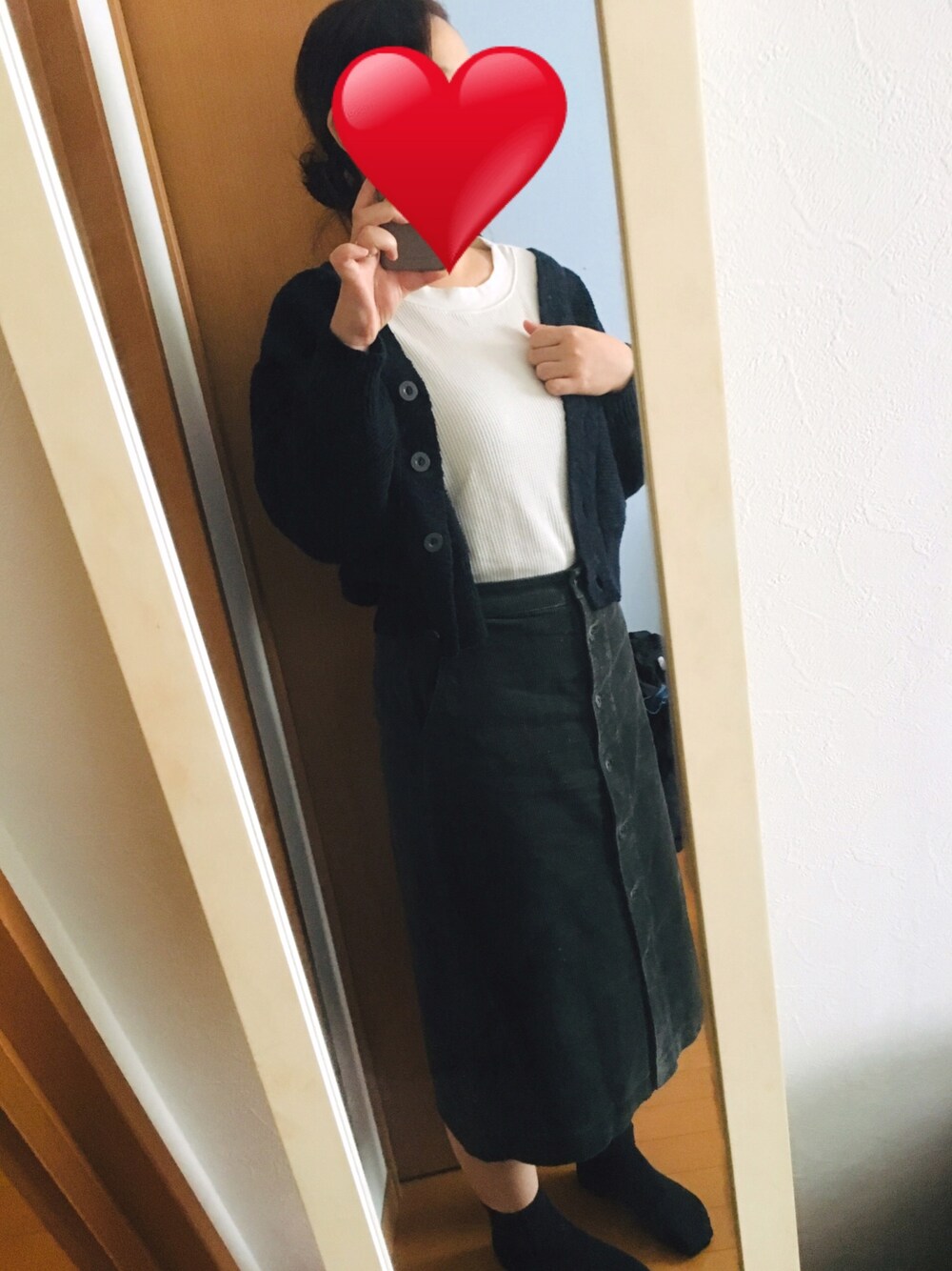 グリーン系のスカート、ブルー系のカーディガン/ボレロ、ホワイト系のTシャツ/カットソーを着用したレディースの秋コーディネートの1枚目の写真