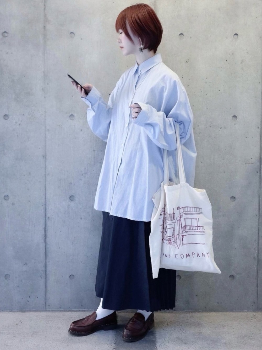 ブルー系のスカート、ブルー系のシャツ/ブラウス、ブラウン系のローファーを着用したレディースの春コーディネートの1枚目の写真