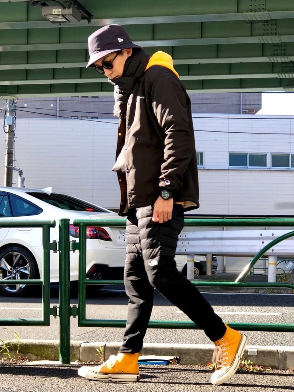 ブラック系のブルゾン、イエロー系のパーカー、ブラック系のその他パンツを着用したメンズの冬コーディネートの1枚目の写真