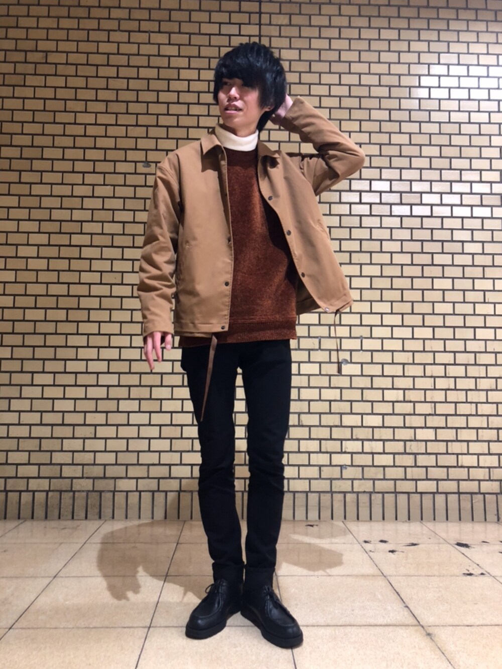 ベージュ系のブルゾン、ブラウン系のニット/セーター、ホワイト系のTシャツ/カットソーを着用したメンズの冬コーディネートの1枚目の写真