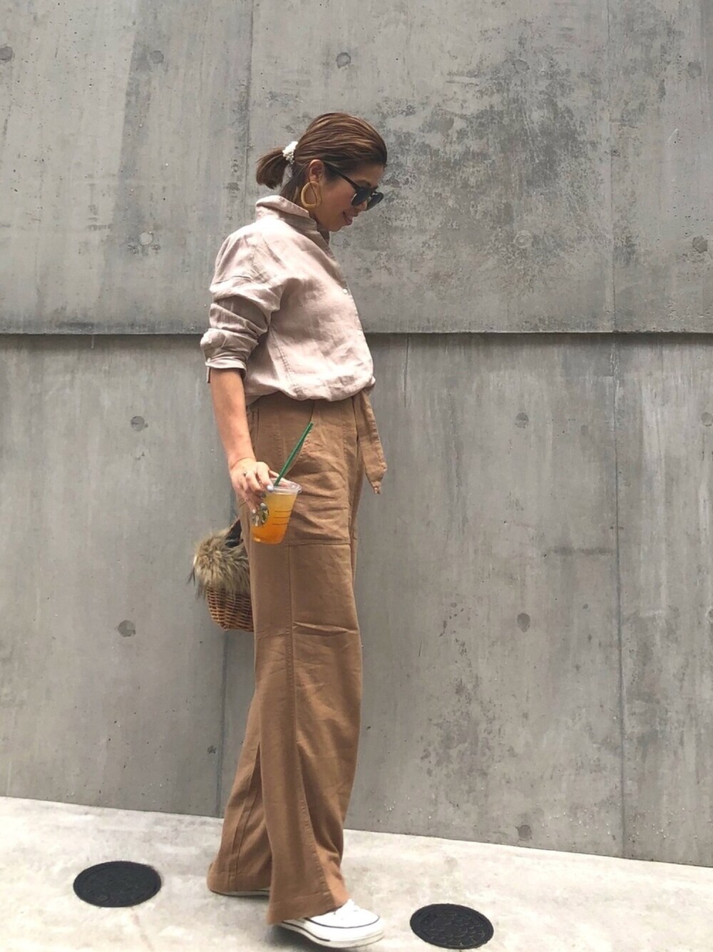 ベージュ系のシャツ/ブラウス、ベージュ系のその他パンツ、ブラウン系のかごバッグを着用したレディースの春コーディネートの1枚目の写真