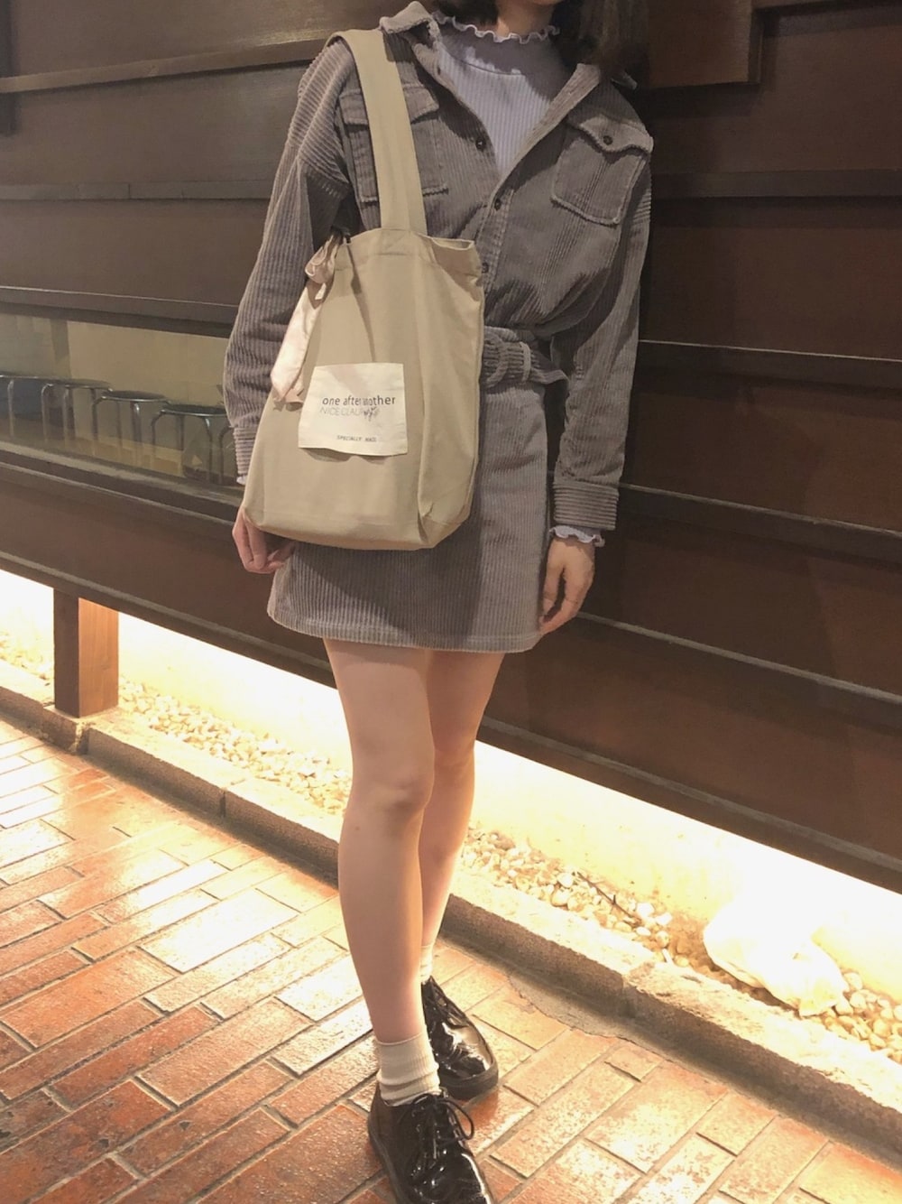 パープル系のジャケット/アウター、パープル系のスカート、ブラック系のスニーカーを着用したレディースの春コーディネートの1枚目の写真