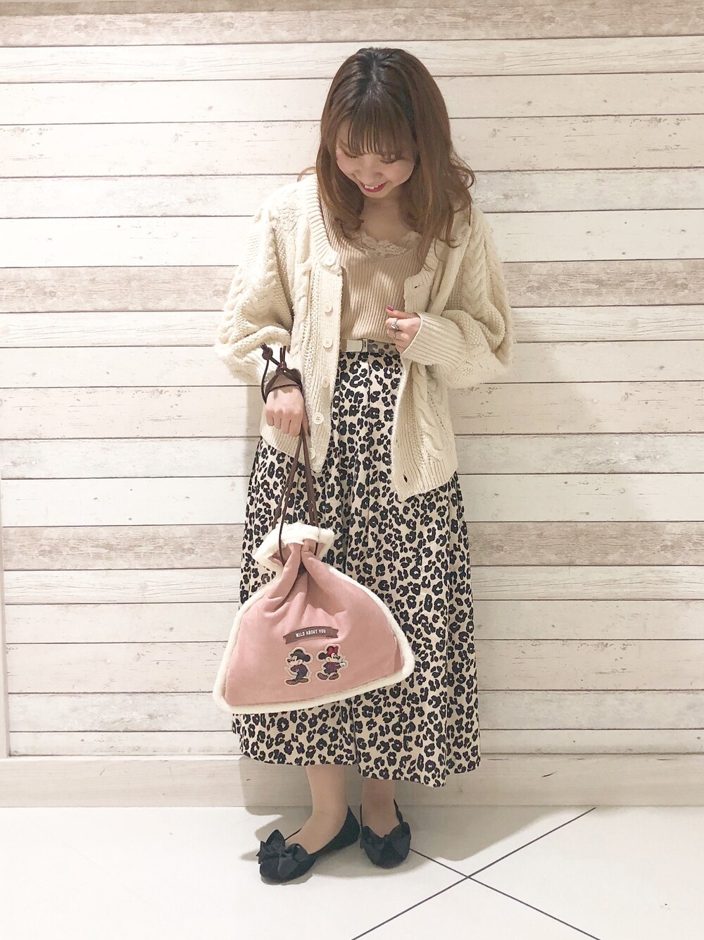 ピンク系のトートバッグを着用したレディースの秋コーディネートの1枚目の写真