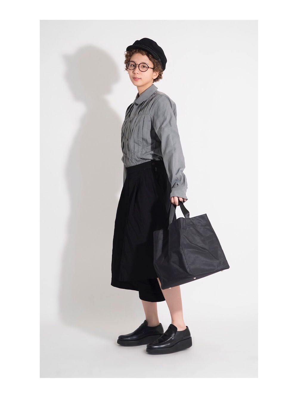グレー系のシャツ/ブラウス、ブラック系のパンツ、ブラック系のバッグを着用したレディースの春コーディネートの1枚目の写真
