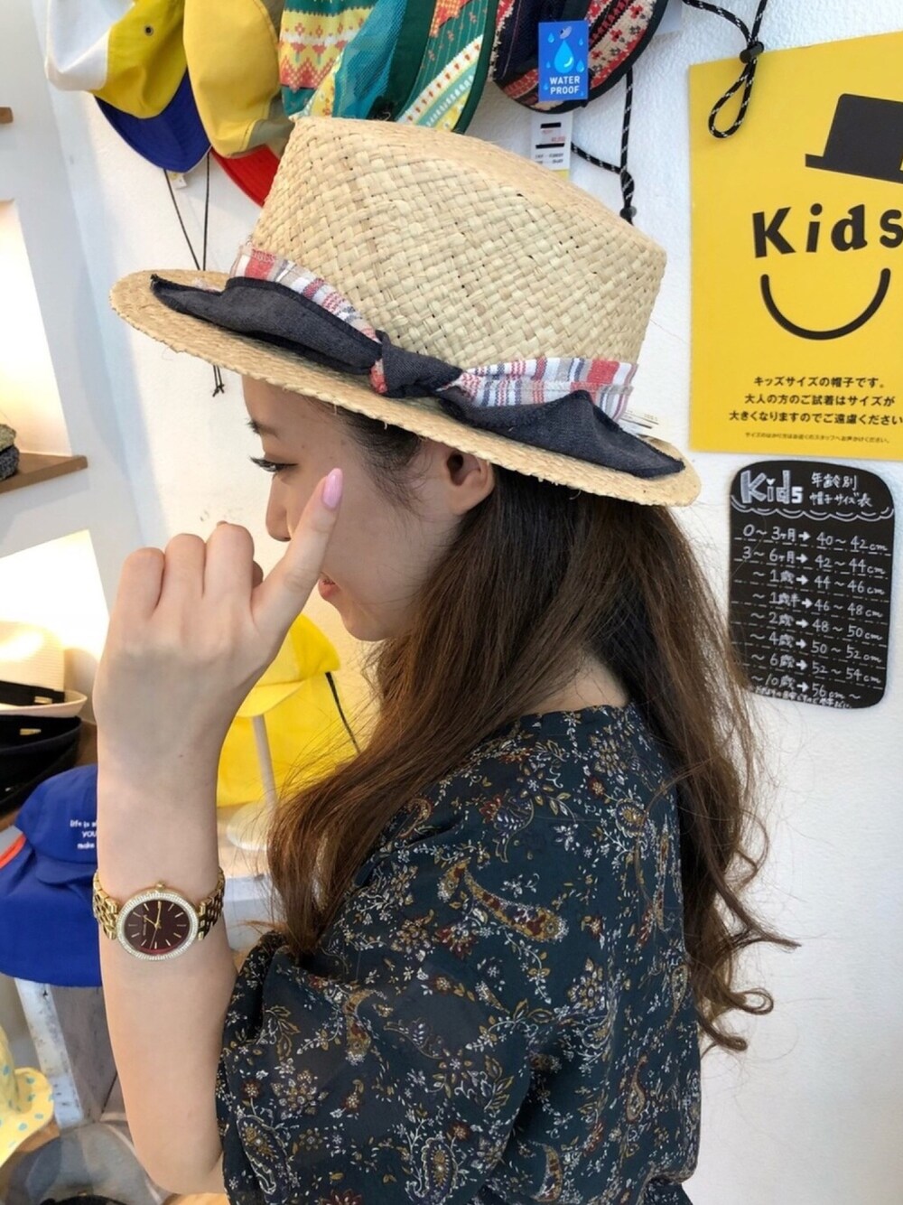 ベージュ系のハットを着用したレディースの夏コーディネートの1枚目の写真