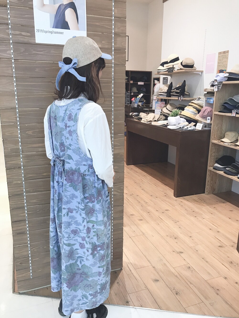 ブルー系のキャップを着用したレディースの春コーディネートの1枚目の写真