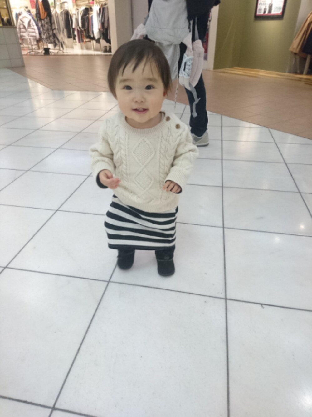 ホワイト系のニット/セーター、その他のスカート、ブラック系のブーツを着用したキッズの冬コーディネートの1枚目の写真