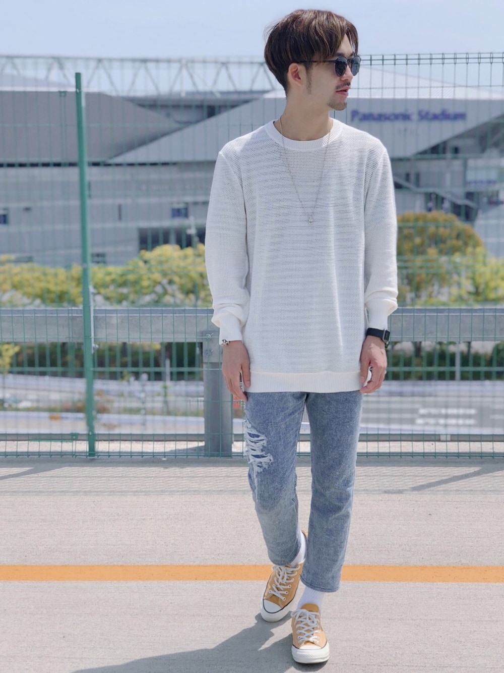 ホワイト系のニット/セーター、ブルー系のデニムパンツ、イエロー系のスニーカーを着用したメンズの春コーディネートの1枚目の写真