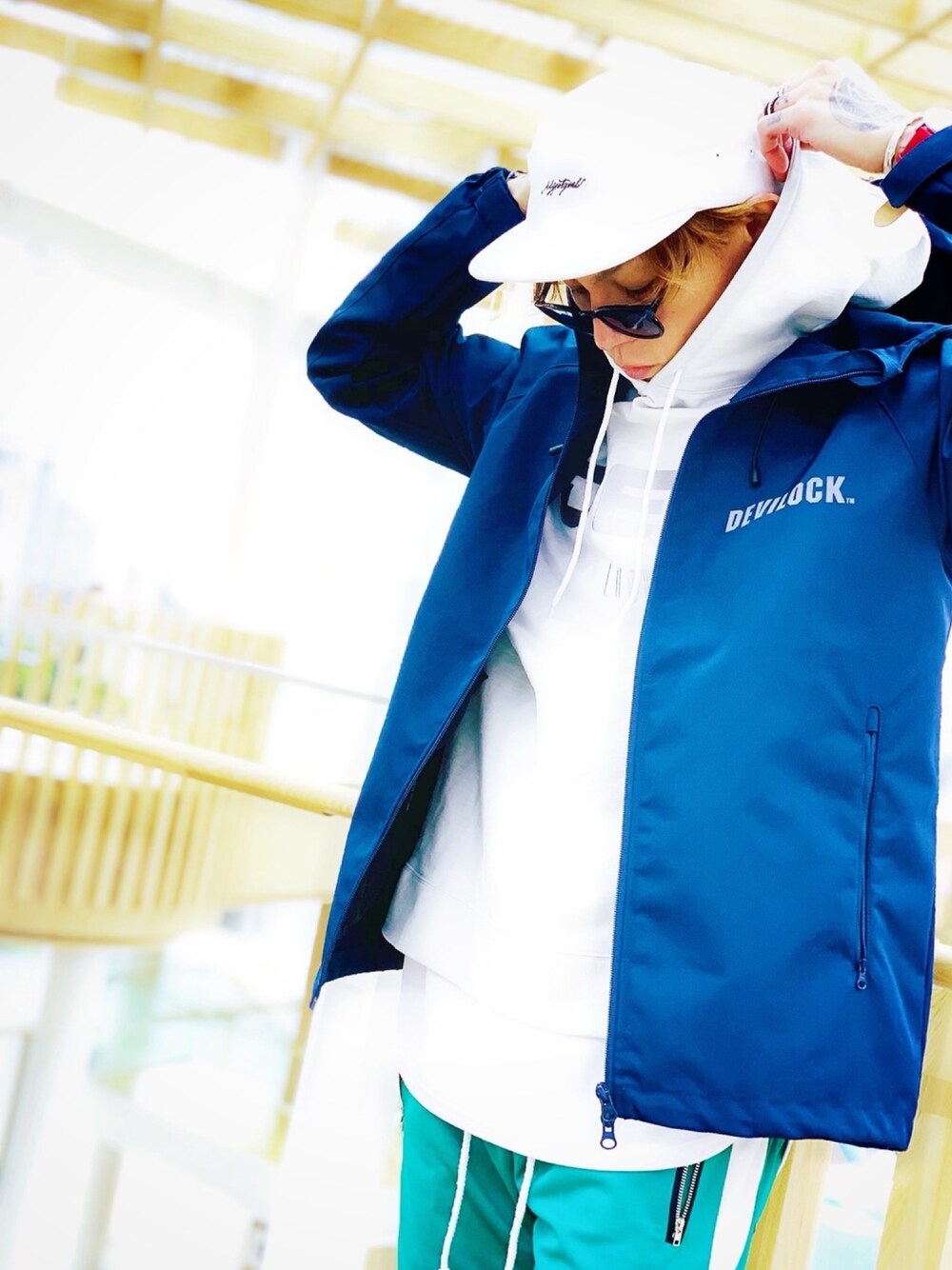 「パーカー、レイヤードスタイル、マウンテンパーカー、DEVILOCK、ジェットキャップ、シルバーアクセサリー、NUMBER (N)INE、STUDIOUS、Hunting World、ハンティングワールド」｜「DEVILOCKの【DEVILOCK】《別注》アーカイブ ロゴ リフレクター プリント マウンテンパーカー（マウンテンパーカー、ブルー系）」を使った、TETUさん（メンズ・174cm）の春コーディネートの1枚目の写真