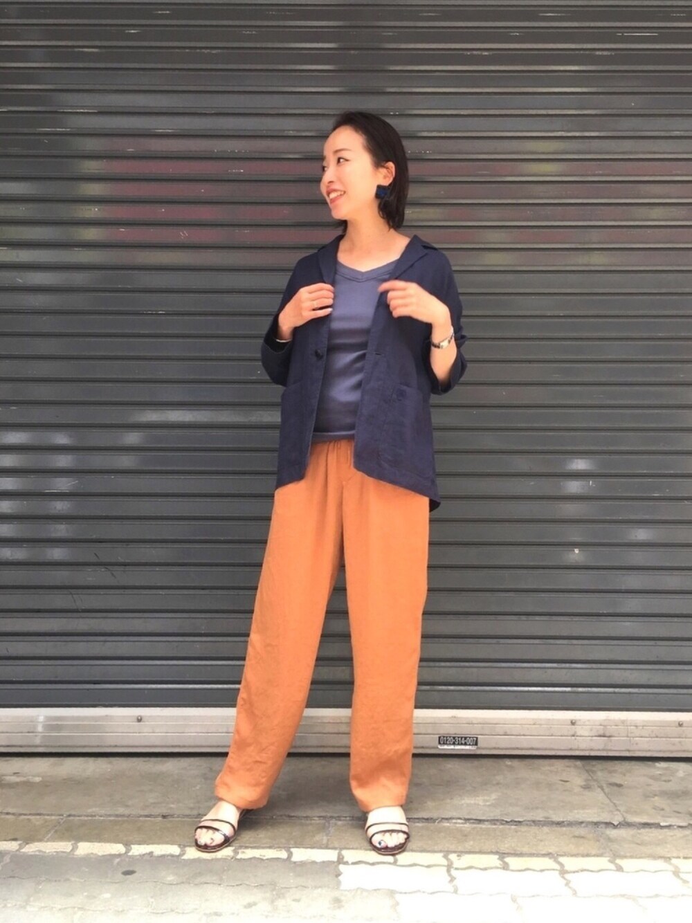 ブルー系のタンクトップ、ブルー系のテーラードジャケット、オレンジ系のその他パンツを着用したレディースの春コーディネートの1枚目の写真