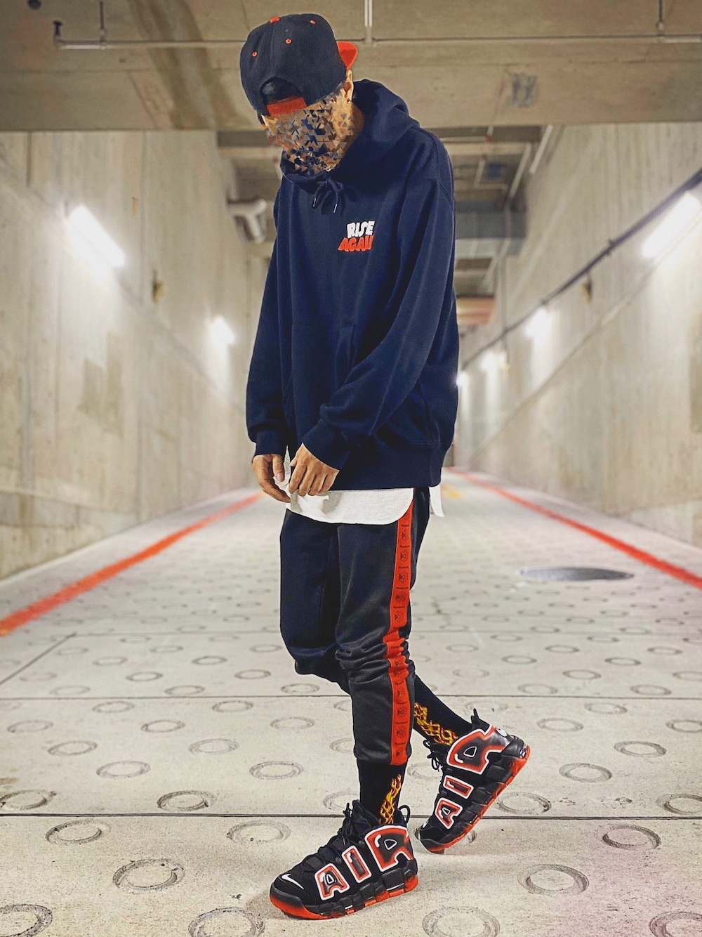 ブラック系のパーカー、ブラック系のパンツ、ブラック系のスニーカーを着用したメンズの冬コーディネートの1枚目の写真