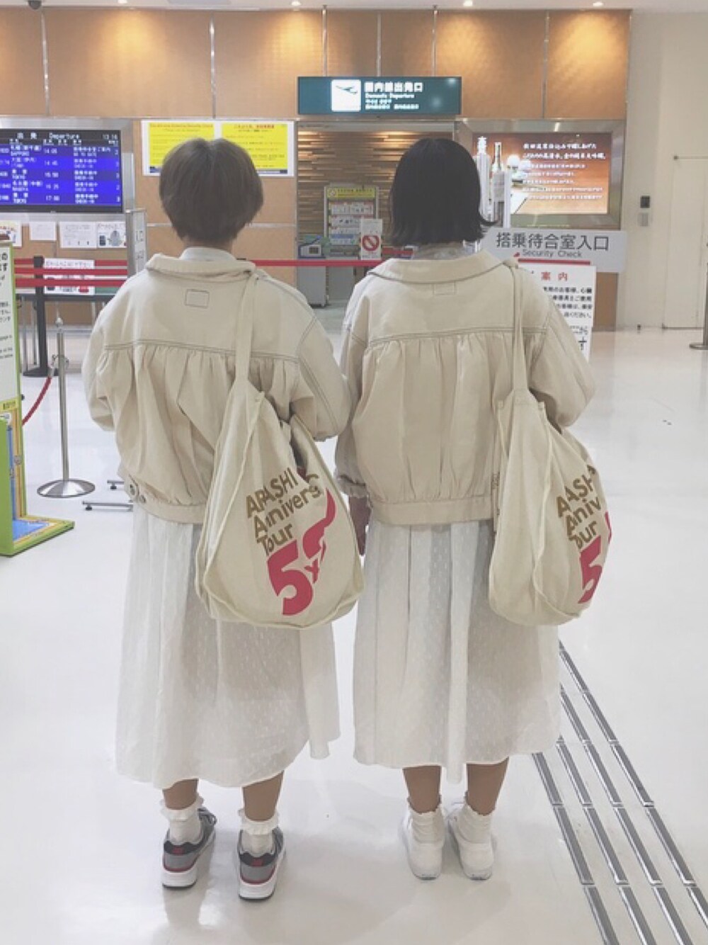 ホワイト系のデニムジャケット、ホワイト系のワンピース、ホワイト系のスニーカーを着用したレディースの春コーディネートの1枚目の写真