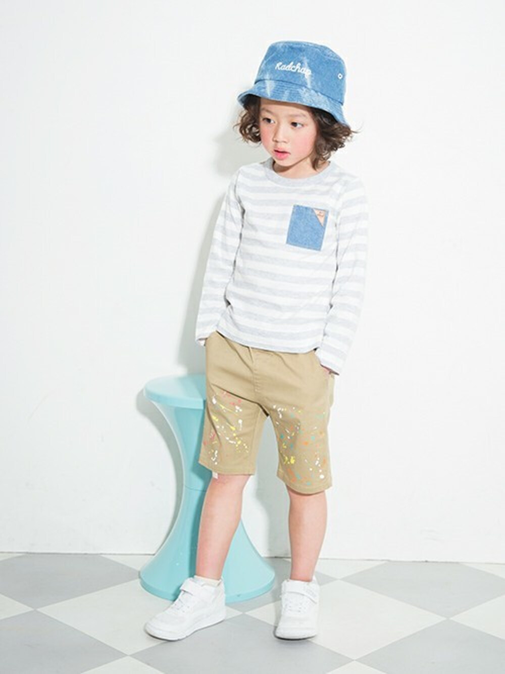 グレー系のTシャツ/カットソー、ベージュ系のチノパンツ、ブルー系のキャップを着用したキッズの冬コーディネートの1枚目の写真