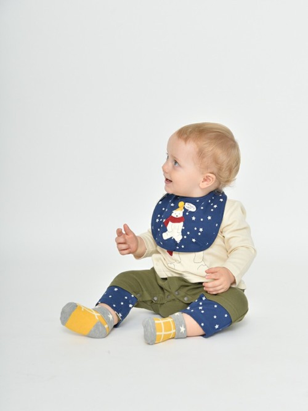 ブルー系のスタイ/よだれかけ、ベージュ系のロンパースを着用したキッズの夏コーディネートの1枚目の写真