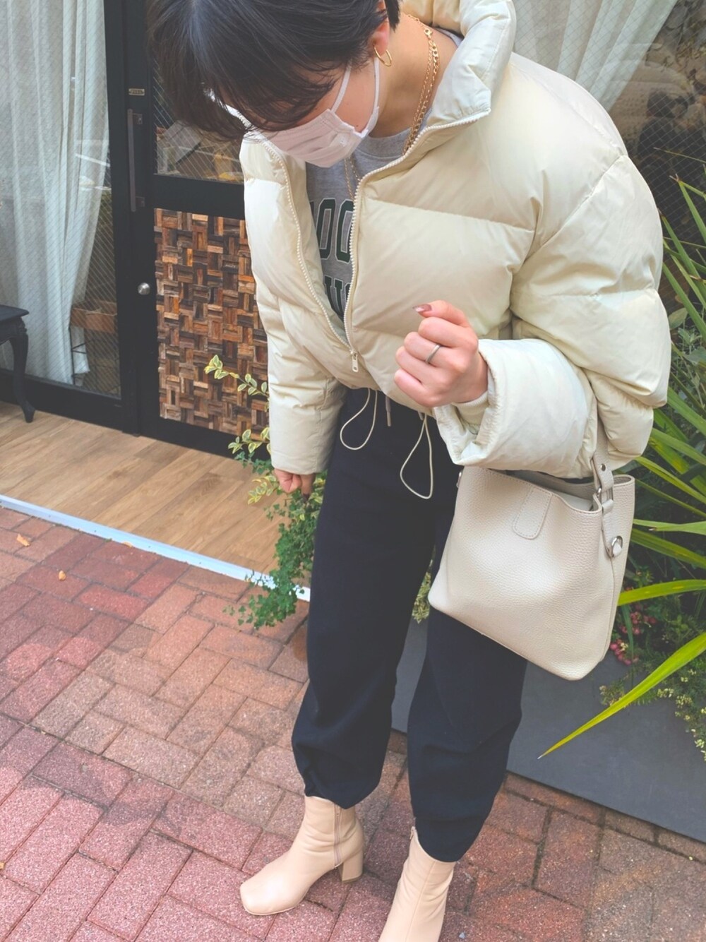 ブラック系のその他パンツ、ベージュ系のブーツ、ベージュ系のダウンジャケット/コートを着用したレディースの冬コーディネートの1枚目の写真