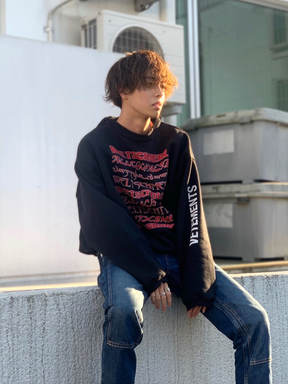 ブラック系のパーカー、ブルー系のデニムパンツを着用したメンズの冬コーディネートの1枚目の写真