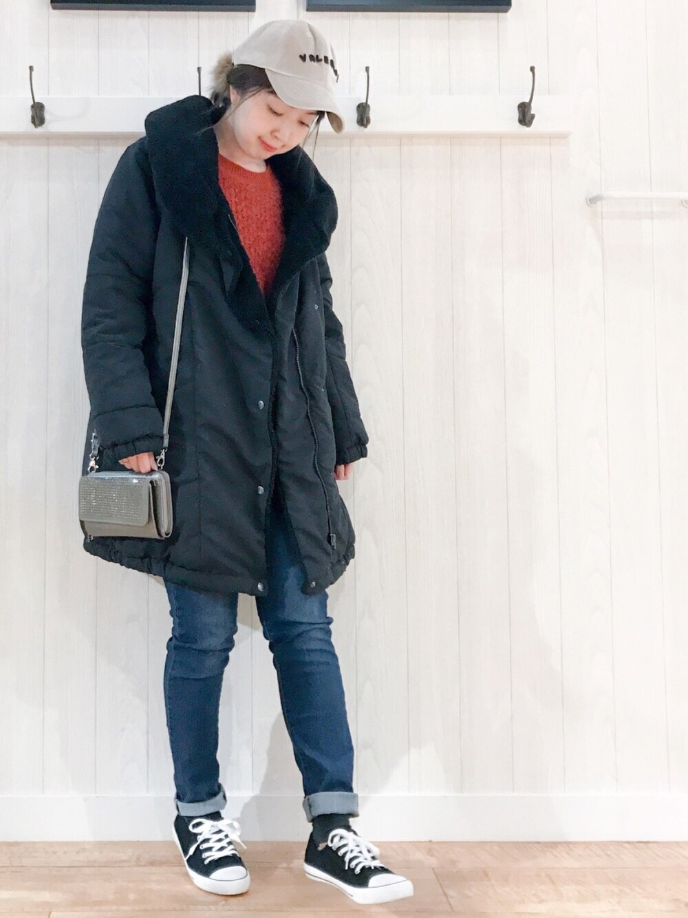 ブラック系のダウンジャケット/コート、ピンク系のニット/セーター、ブルー系のデニムパンツを着用したレディースの冬コーディネートの1枚目の写真