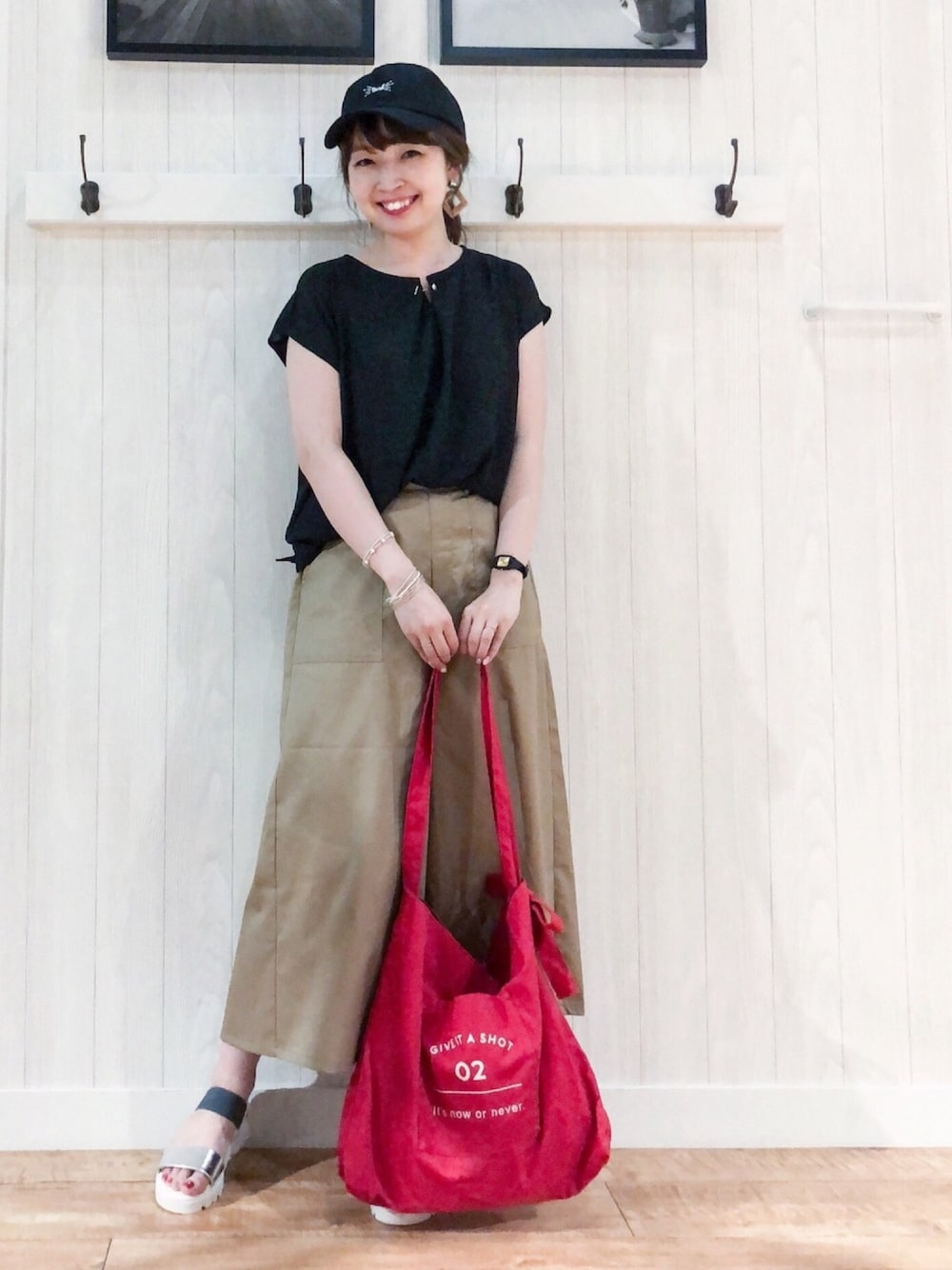 ブラック系のTシャツ/カットソー、ベージュ系のその他パンツ、レッド系のトートバッグを着用したレディースの夏コーディネートの1枚目の写真