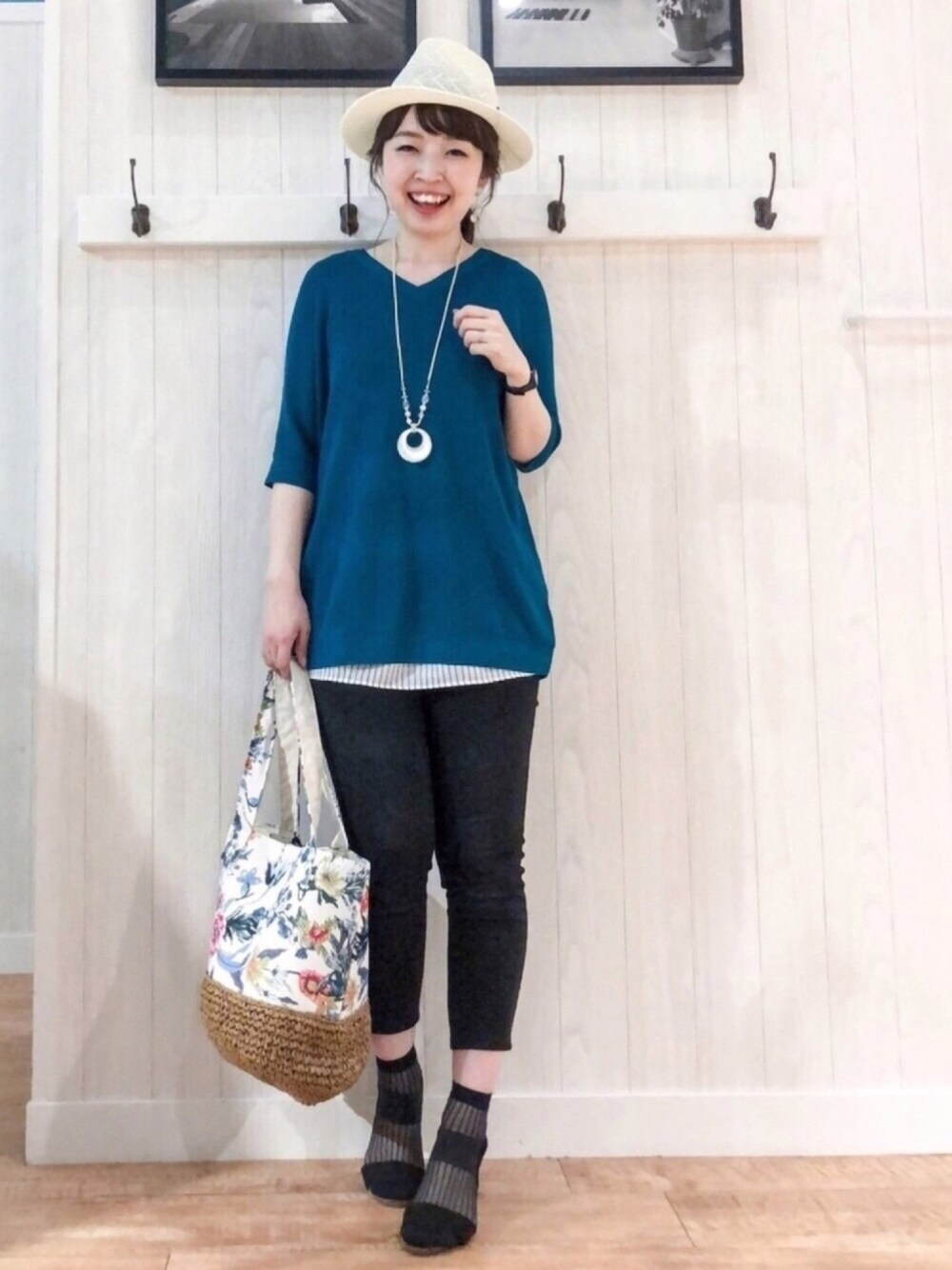 ブラック系のその他パンツ、ブルー系のニット/セーター、ホワイト系のトートバッグを着用したレディースの春コーディネートの1枚目の写真