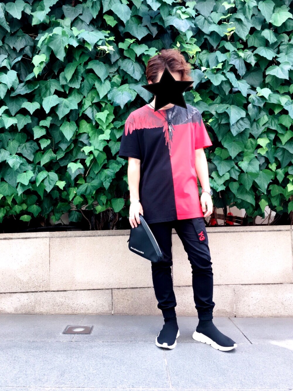 レッド系のTシャツ/カットソー、ブラック系のクラッチバッグ、ブラック系のその他パンツを着用したメンズの夏コーディネートの1枚目の写真