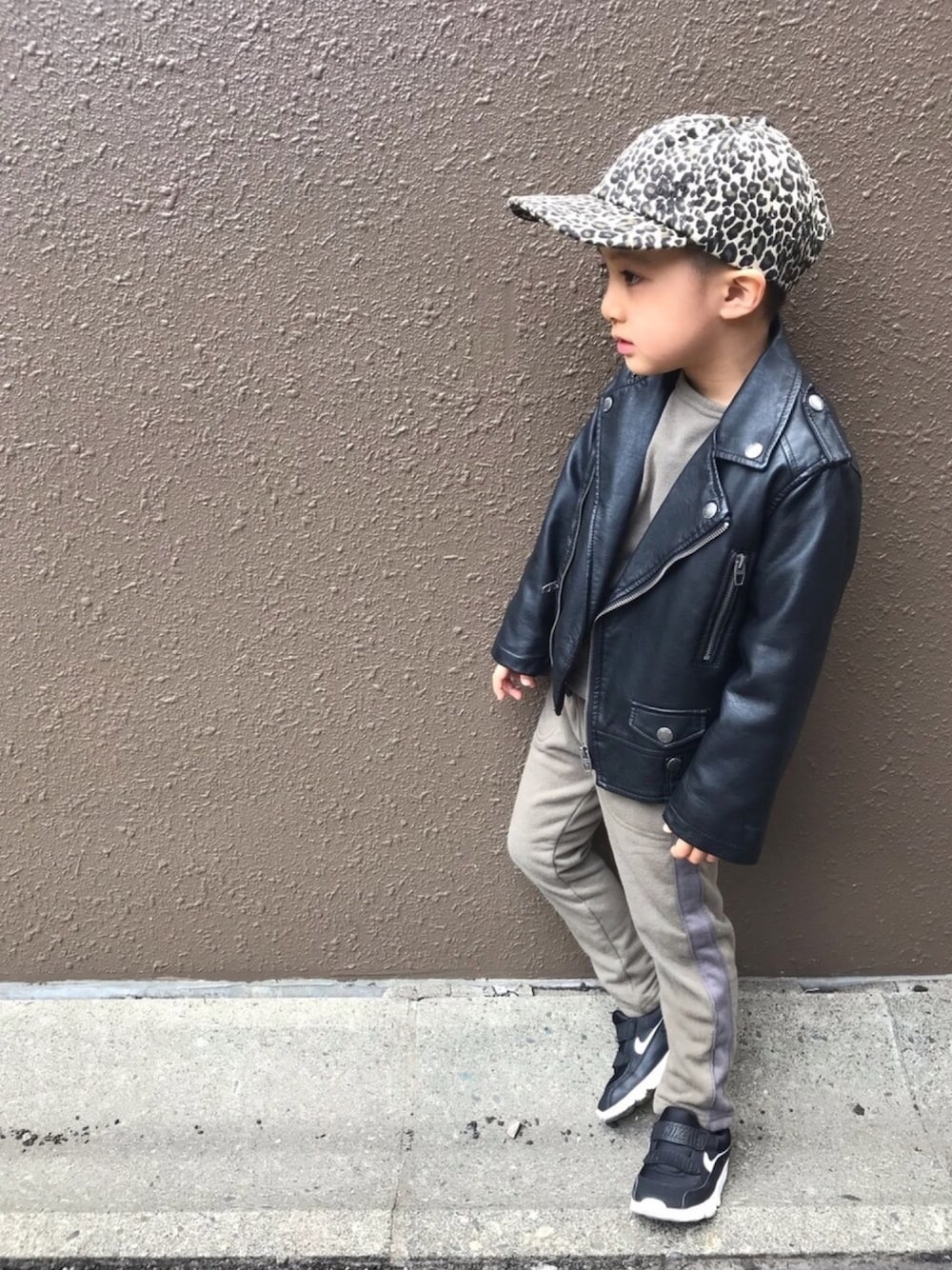 ブラック系のライダースジャケット、グリーン系のスウェット、グリーン系のスウェットパンツを着用したキッズの春コーディネートの1枚目の写真