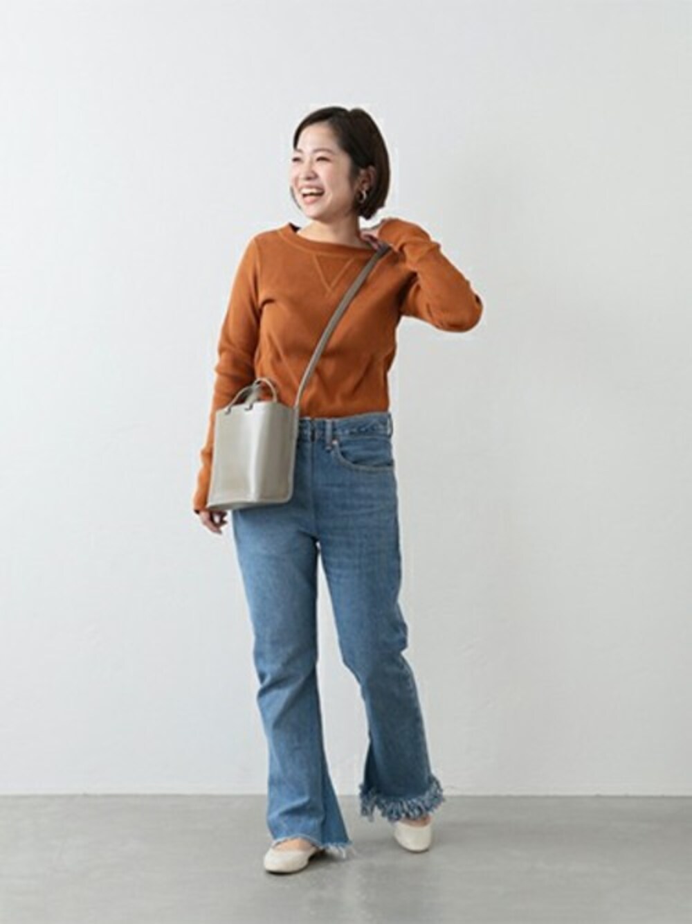 ブラウン系のTシャツ/カットソー、ホワイト系のパンプスを着用したレディースの冬コーディネートの1枚目の写真