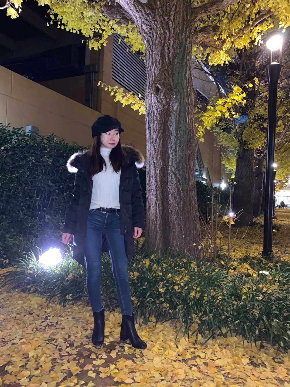 ブラック系のブーツ、ブルー系のデニムパンツ、ホワイト系のニット/セーターを着用したレディースの冬コーディネートの1枚目の写真